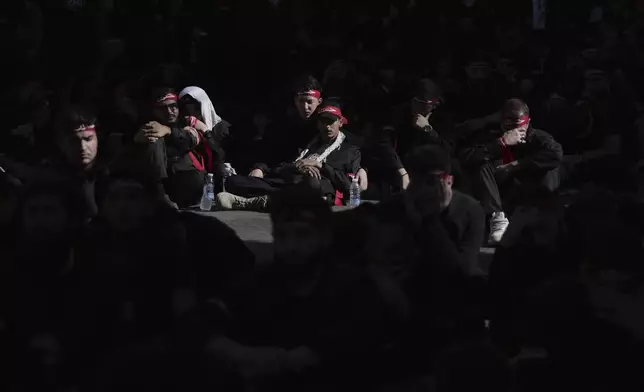 Hezbollah supporters listen during a sermon to the story of Ashoura, the Shiite Muslim commemoration marking the death of Imam Hussein, the grandson of the Prophet Muhammad, at the Battle of Karbala in present-day Iraq in the 7th century, in the southern suburbs of Beirut, Lebanon, Sunday, July 6, 2025. (AP Photo/Hassan Ammar)