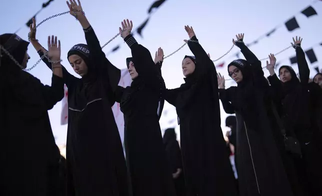 A Shiite faithful Muslim child attends an Ashoura procession to mark the tenth day of the Muharram month, in Istanbul, Turkey, Saturday, July 5, 2025. (AP Photo/Francisco Seco)