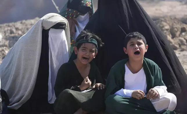 Shiite Muslims re-enact the seventh century battle of Karbala during activities marking the holy day of Ashoura, the annual Shiite Muslim commemoration marking the death of Imam Hussein, the grandson of the Prophet Muhammad, in the Shiite neighborhood of Sadr City, Baghdad, Iraq, Sunday, July 6, 2025. (AP Photo/Hadi Mizban)