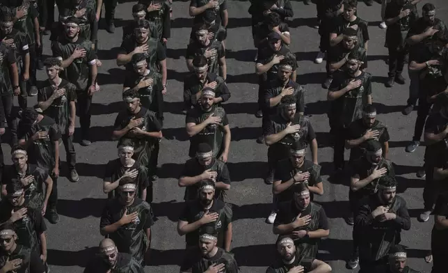 Hezbollah supporters beat their chests as they march during Ashoura, the Shiite Muslim commemoration marking the 7th-century death of Imam Hussein, the grandson of the Prophet Muhammad, at the Battle of Karbala, in the southern suburbs of Beirut, Lebanon, Sunday, July 6, 2025. (AP Photo/Hassan Ammar)