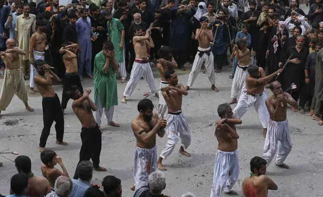 Shiite Muslim flagellate themselves in a ritual during an Ashoura procession, in Peshawar, Pakistan, Sunday, July 6, 2025. (AP Photo/Muhammad Sajjad)