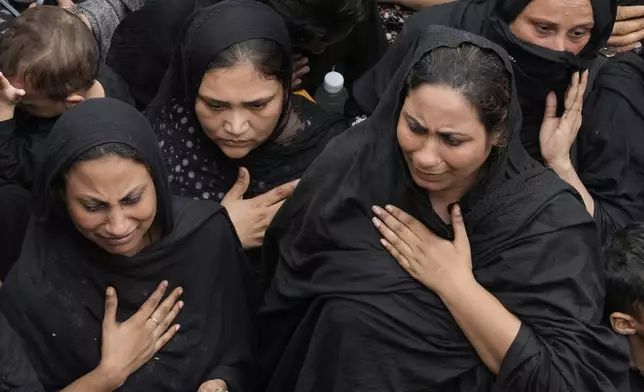 Shiite Muslim women take part in a ritual during an Ashoura procession in Lahore, Pakistan, Sunday, July 6, 2025. (AP Photo/K.M. Chaudary)
