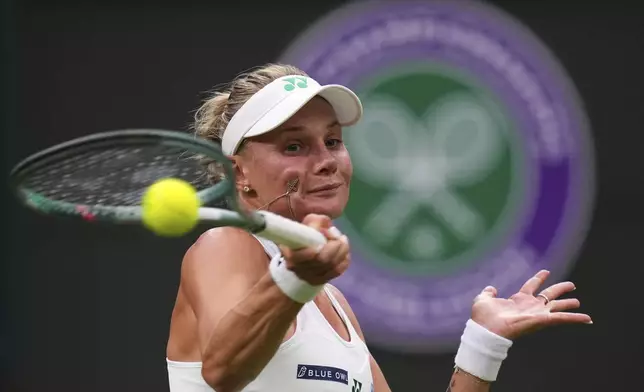 Dayana Yastremska of Ukraine returns the ball to Coco Gauff of the U.S. during their first round women's single match at the Wimbledon Tennis Championships in London, Tuesday, July 1, 2025.(AP Photo/Kirsty Wigglesworth)