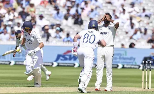 India's Jasprit Bumrah reacts as England's Ollie Pope, middle, and England's Joe Root run between the wickets to score during the third cricket test match between England and India at Lord's cricket ground in London, Thursday, July 10, 2025. (AP Photo/Richard Pelham)
