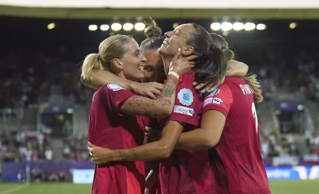 Poland's Natalia Padilla, centre, celebrates with teammates after scoring her side's opening goal during the Women's Euro 2025, group C, soccer match between Poland and Denmark at Allmend Stadion Luzern in Lucerne, Switzerland, Saturday, July 12, 2025. (AP Photo/Alessandra Tarantino)
