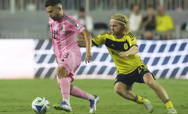 Inter Miami defender Jordi Alba (18) runs with the ball as Nashville SC midfielder Edvard Tagseth (20) defends during the second half of an MLS soccer match, Saturday, July 12, 2025, in Fort Lauderdale, Fla. (AP Photo/Lynne Sladky)