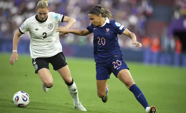 France's Delphine Cascarino vies for the ball with Germany's Sarai Linder, left, during the Women's Euro 2025 quarterfinals soccer match between France and Germany at St. Jakob-Park in Basel, Switzerland, Saturday, July 19, 2025. (AP Photo/Alessandra Tarantino)