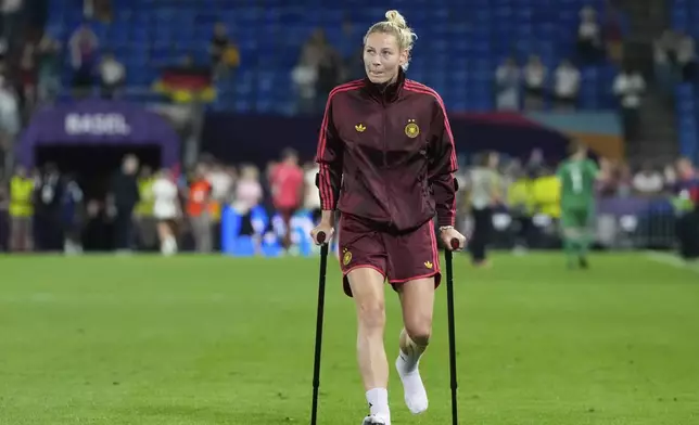 Germany's Sarai Linder, who got injured during the match, walks on the pitch at the end of the Women's Euro 2025 quarterfinals soccer match between France and Germany at St. Jakob-Park in Basel, Switzerland, Saturday, July 19, 2025. (AP Photo/Alessandra Tarantino)