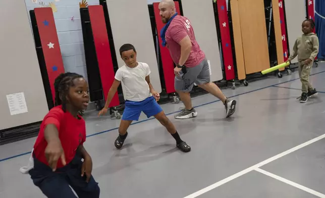 Children play tag during the East Providence Boys and Girls Club Summer Camp at Emma G. Whiteknact Elementary School on Thursday, July 10, 2025, in Providence, R.I. (AP Photo/Sophie Park)