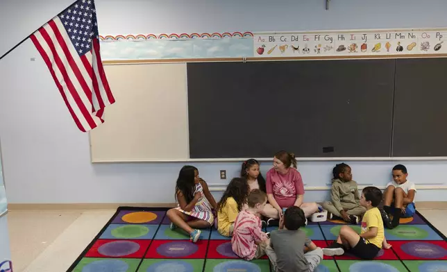 Jillian Murphy leads children in math activities during the East Providence Boys and Girls Club Summer Camp at Emma G. Whiteknact Elementary School on Thursday, July 10, 2025, in Providence R.I. (AP Photo/Sophie Park)
