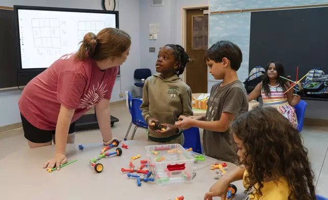 Children play with building blocks before participating in math activities during the East Providence Boys and Girls Club Summer Camp at Emma G. Whiteknact Elementary School on Thursday, July 10, 2025, in Providence R.I. (AP Photo/Sophie Park)