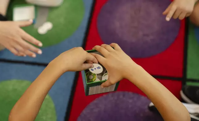 Children participate in math activities during the East Providence Boys and Girls Club Summer Camp at Emma G. Whiteknact Elementary School on Thursday, July 10, 2025, in Providence R.I. (AP Photo/Sophie Park)