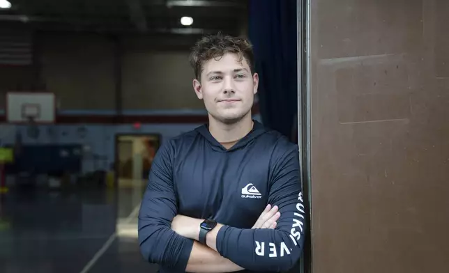 Nate Monteiro, 17, who grew up in the East Providence Boys and Girls Club and now works at the club, poses for a portrait at Emma G. Whiteknact Elementary School on Thursday, July 10, 2025, in Providence, R.I. (AP Photo/Sophie Park)