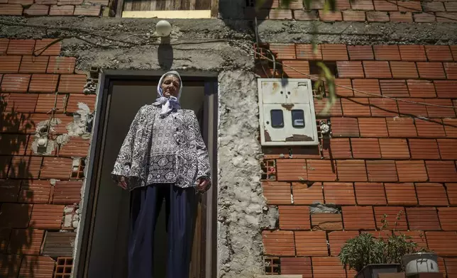 Sefika Mustafic, 72, stands in front of her home in the village of Potocari near Srebrenica, Bosnia, on June 29, 2025. During the genocide a total of 15 members of her family were killed. (AP Photo/Armin Durgut)