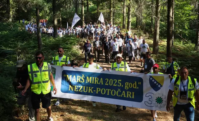 People participate in the "March of Peace" in memory of the 1995 Srebrenica massacre, in Nezuk, Bosnia, Tuesday, July 8, 2025. (AP Photo/Armin Durgut)