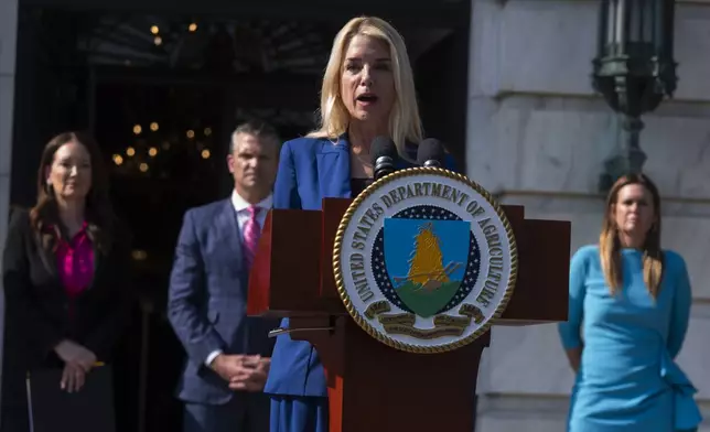 Attorney General Pam Bondi, front, with Agriculture Secretary Brooke Rollins, back left to right, Secretary of Defense Pete Hegseth and Arkansas Gov. Sarah Huckabee Sanders, speaks during a news conference at the Department of Agriculture to rollout the USDA'S National Farm Security Action Plan and discuss actions being taken to protect American agriculture from foreign threats in Washington, Tuesday, July 8, 2025. (AP Photo/Manuel Balce Ceneta)