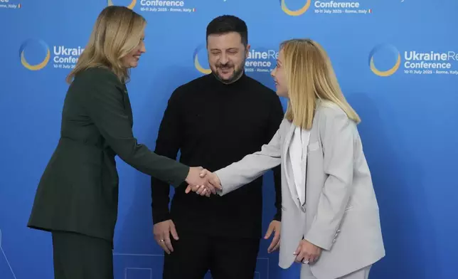 Ukraine's President Volodymyr Zelenskyy, and his wife Olena Zelenska are welcomed by Italian Prime Minister Giorgia Meloni during the Ukraine Recovery Conference at La Nuvola convention center in Rome, Thursday, July 10, 2025. (AP Photo/Gregorio Borgia)