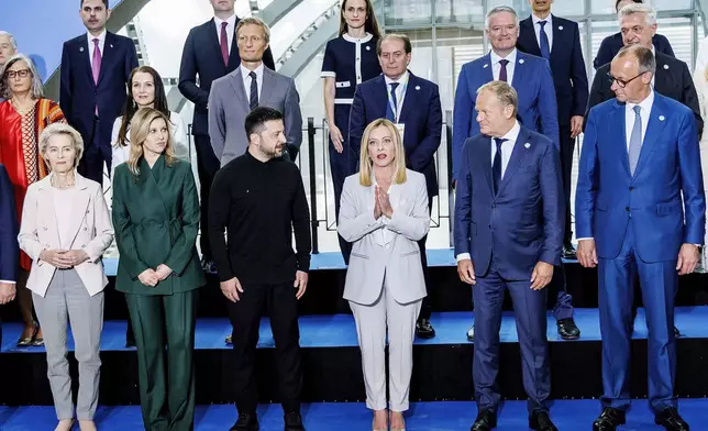 Front row from left, European Commission President Ursula von der Leyen, Olena Zelenska, Ukrainian President Volodymyr Zelenskyy, Italian Premier Giorgia Meloni, Polish Prime Minister Donald Tusk and German Chancellor Friedrich Merz pose for a family photo on the occasion of the Ukraine Recovery Conference at La Nuvola convention center in Rome, Thursday, July 10, 2025. (Mauro Scrobogna/LaPresse via AP)