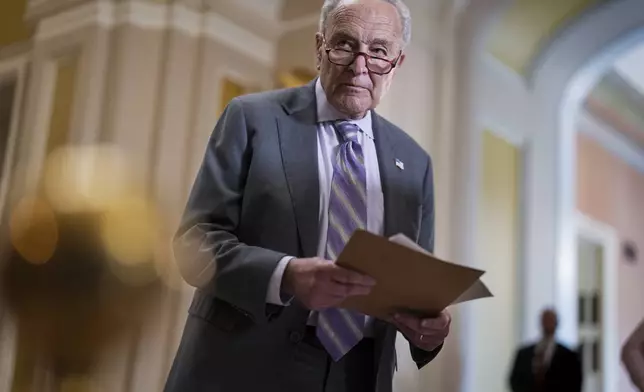 Senate Minority Leader Chuck Schumer, D-N.Y., looks over notes as Senate Republicans work to cancel $9.4 billion in previously approved spending targeted by DOGE, at the Capitol in Washington, Tuesday, July 15, 2025. (AP Photo/J. Scott Applewhite)