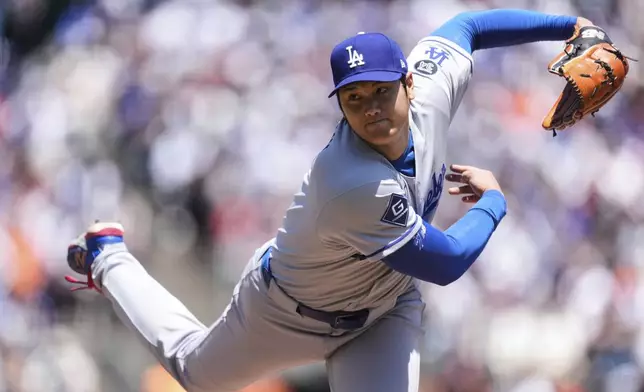 Los Angeles Dodgers' Shohei Ohtani follows through on his pitch to a San Francisco Giants batter during the third inning of a baseball game Saturday, July 12, 2025, in San Francisco. (AP Photo/Godofredo A. Vásquez)