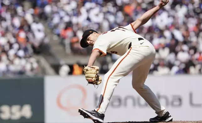 San Francisco Giants pitcher Tyler Rogers throws to a Los Angeles Dodgers batter during the ninth inning of a baseball game Saturday, July 12, 2025, in San Francisco. (AP Photo/Godofredo A. Vásquez)