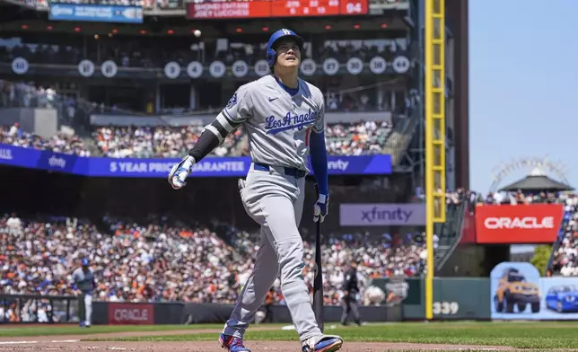Los Angeles Dodgers' Shohei Ohtani reacts as he walks to the dugout after striking out during the seventh inning of a baseball game against the San Francisco Giants Saturday, July 12, 2025, in San Francisco. (AP Photo/Godofredo A. Vásquez)