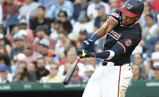 Washington Nationals' James Wood hits an RBI single during the fourth inning of a baseball game against the Detroit Tigers, Thursday, July 3, 2025, in Washington. (AP Photo/Daniel Kucin Jr.)