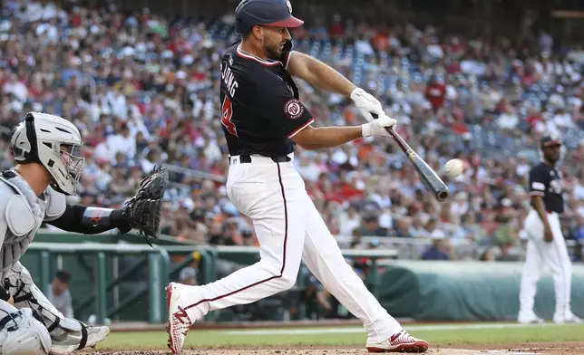 Washington Nationals' Paul DeJong hits a home run during the first inning of a baseball game against the Detroit Tigers, Thursday, July 3, 2025, in Washington. (AP Photo/Daniel Kucin Jr.)