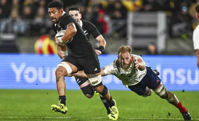 New Zealand's Ardie Savea breaks a tackle as he makes a run during the second rugby union international between the All Blacks and France in Wellington, New Zealand, Saturday, July 12, 2025. (Kerry Marshall /Photosport via AP)