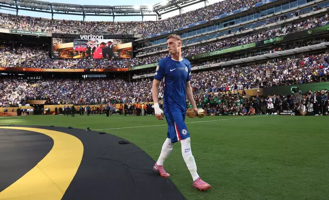Chelsea's Cole Palmer walks with the golden ball trophy after Chelsea won against Paris St Germain in the Club World Cup final, at MetLife Stadium in East Rutherford, N.J., Sunday, July 13, 2025. (Kevin Lamarque/Pool Photo via AP)