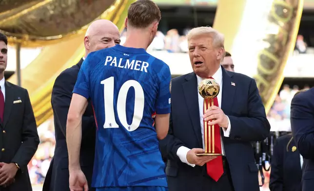 President Donald Trump presents Chelsea's Cole Palmer with the golden ball trophy after Chelsea won against Paris St Germain in the Club World Cup final at MetLife Stadium in East Rutherford, N.J., Sunday, July 13, 2025. (Kevin Lamarque/Pool Photo via AP)