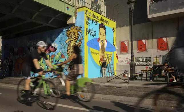 Artist Franck Duval, aka FKDL, works on a mural of U.S.-French entertainer and civil rights activist Josephine Baker in Paris, Saturday, July 19, 2025. (AP Photo/Thomas Padilla)