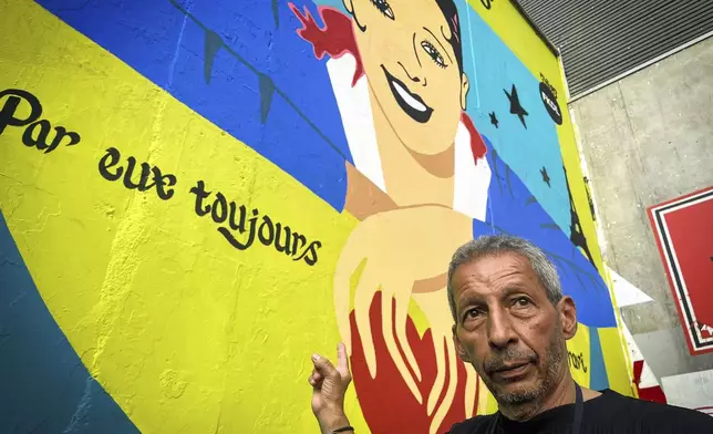 Brian Baker, son of U.S.-French entertainer and civil rights activist Josephine Baker, stands in front of a new mural of his mother painted by artist Franck Duval, aka FKDL, in Paris, Saturday, July 19, 2025. (AP Photo/Thomas Padilla)
