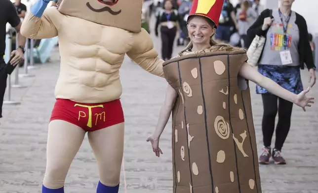 Ryan Martinez of Houston dressed as Powdered Toast Man, left, and Tarrah Martinez of Houston dressed as Log from "The Ren &amp; Stimpy Show" attend Comic-Con International on Friday, July 25, 2025, in San Diego. (Photo by Andrew Park/Invision/AP)