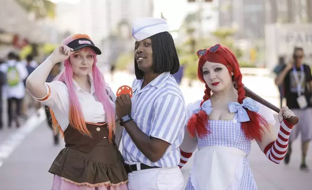 Diana, from left, Kal Smith, and Melissa Ann from San Diego, Calif. pose during preview night for Comic-Con International on Wednesday, July 23, 2025, in San Diego. (Photo by Andrew Park/Invision/AP)