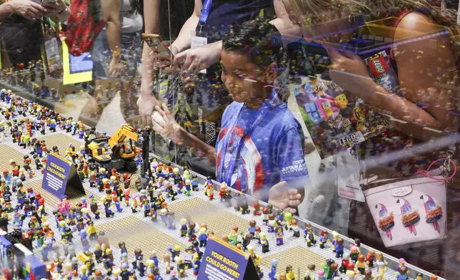 Onlookers view a Lego installation during preview night for Comic-Con International on Wednesday, July 23, 2025, in San Diego. (Photo by Andrew Park/Invision/AP)