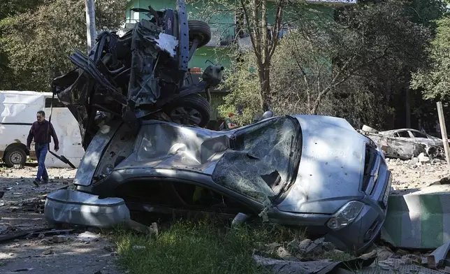 Damaged cars lie in a yard among other debris after a Russian drone and missile attacks in Kyiv, Ukraine, Friday, July 4, 2025. (AP Photo/Efrem Lukatsky)