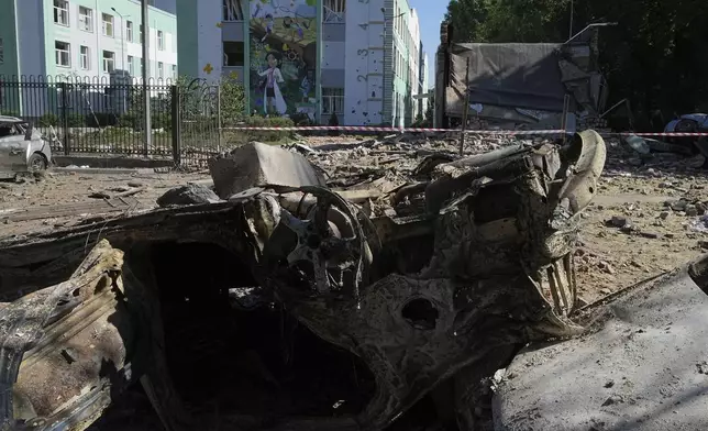 Damaged cars lie in a yard among other debris after a Russian drone and missile attacks in Kyiv, Ukraine, Friday, July 4, 2025. (AP Photo/Efrem Lukatsky)