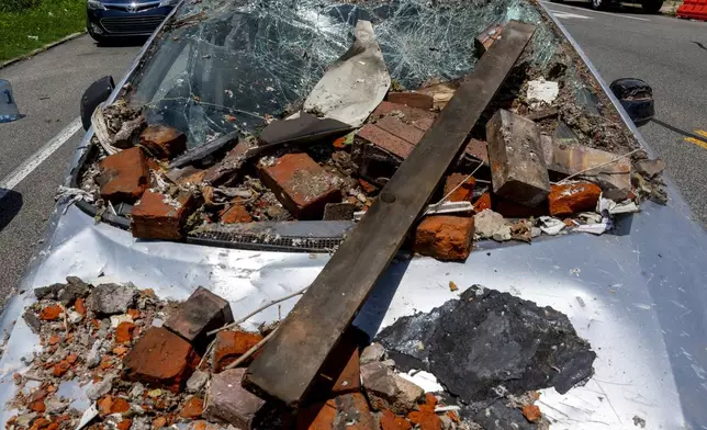 Debris covers a vehicle in the Nicetown area of Philadelphia, Sunday, June 29, 2025, after an explosion damaged several homes. (Tom Gralish/The Philadelphia Inquirer via AP)
