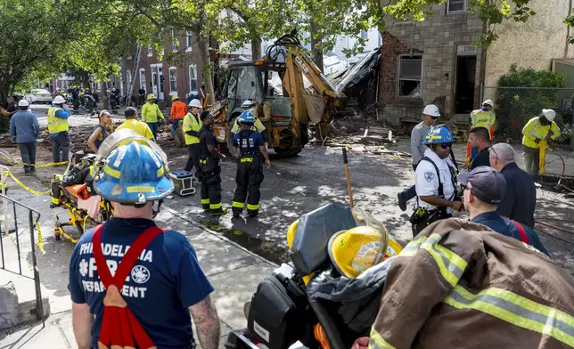 Officials work the scene in the Nicetown area of Philadelphia, Sunday, June 29, 2025, after an explosion damaged several homes. (Tom Gralish/The Philadelphia Inquirer via AP)