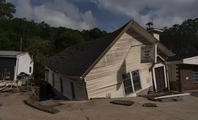 The Valley Grove Assembly of God, twisted and moved from its foundation by floodwaters, Monday, June 16, 2025, in Valley Grove, W.Va. (AP Photo/Carolyn Kaster)