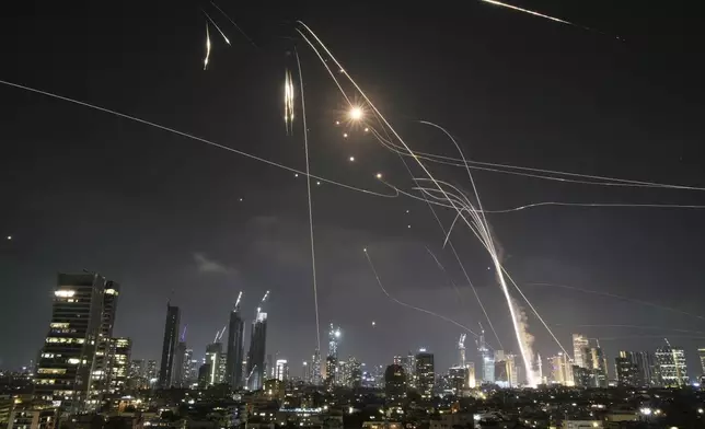 Israeli Iron Dome air defense system fires to intercept missiles over Tel Aviv, Israel, Friday, June 13, 2025. (AP Photo/Leo Correa)