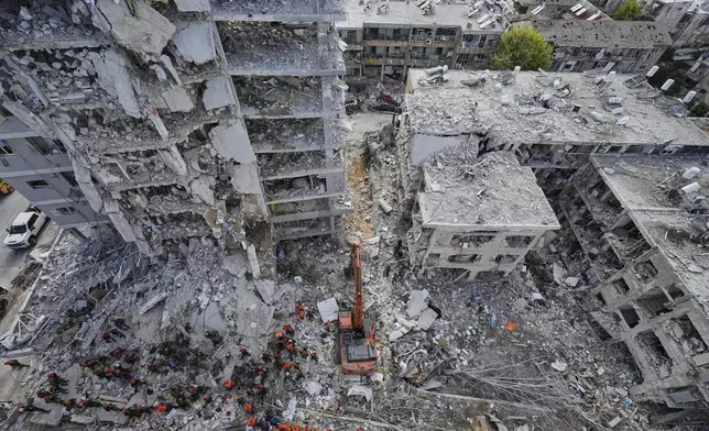 Israeli soldiers search through the rubble of residential buildings destroyed by an Iranian missile strike in Bat Yam, central Israel, Sunday, June 15, 2025. (AP Photo/Baz Ratner)