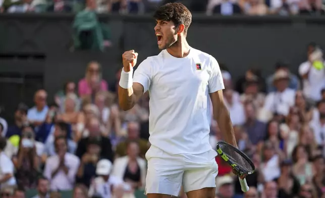Spain's Carlos Alcaraz celebrates after beating Britain's Cameron Norrie during a quarterfinal men's singles match at the Wimbledon Tennis Championships in London, Tuesday, July 8, 2025. (AP Photo/Kirsty Wigglesworth)
