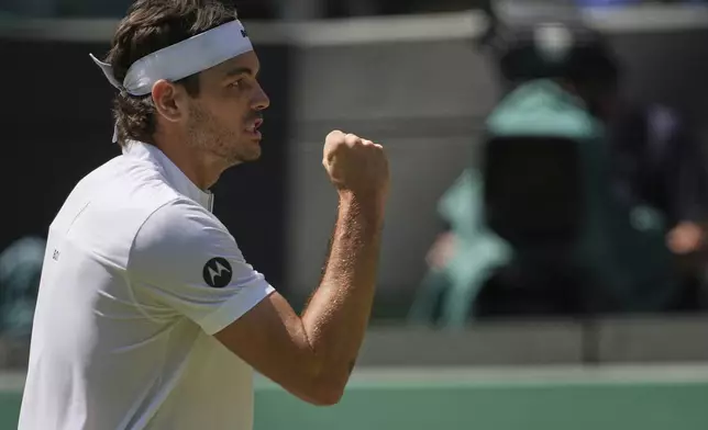 Taylor Fritz of the U.S. reacts during the men's singles quarter final match against Karen Khachanov of Russia at the Wimbledon Tennis Championships in London, Tuesday, July 8, 2025.(AP Photo/Kin Cheung)