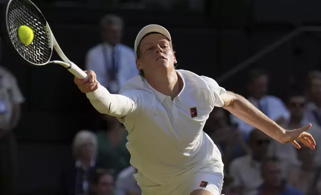 Italy's Jannik Sinner returns to Serbia's Novak Djokovic in a men's singles semifinal at the Wimbledon Tennis Championships in London, Friday, July 11, 2025. (AP Photo/Kin Cheung)
