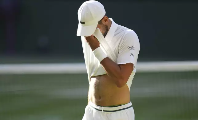 Novak Djorkovic of Serbia reacts during the men's semifinal singles match against Jannik Sinner of Italy at the Wimbledon Tennis Championships in London, Friday, July 11, 2025.(AP Photo/Kirsty Wigglesworth)