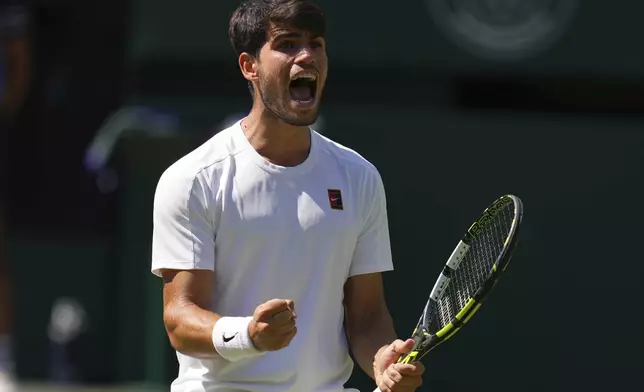 Carlos Alcaraz of Spain reacts during the men's semifinal singles match against Taylor Fritz of the U.S. at the Wimbledon Tennis Championships in London, Friday, July 11, 2025.(AP Photo/Kirsty Wigglesworth)
