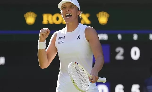 Iga Swiatek of Poland celebrates winning the women's singles semifinal match against Belinda Bencic of Switzerland at the Wimbledon Tennis Championships in London, Thursday, July 10, 2025.(AP Photo/Kirsty Wigglesworth)
