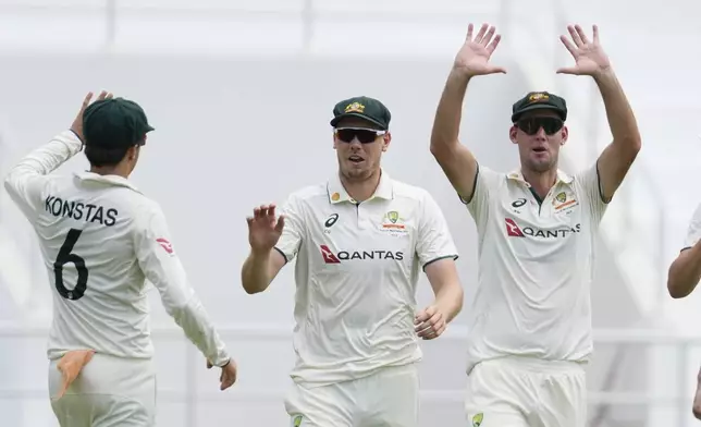 Australia's Cameron Green, center, celebrates with Beau Webster, and Sam Konstas after taking the catch to dismiss West Indies' Alzarri Joseph on day four of the second cricket Test match at the National Cricket Stadium in St. George's, Grenada, Sunday, July 6, 2025. (AP Photo/Ricardo Mazalan)